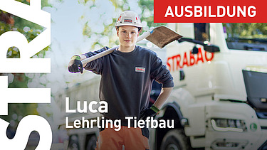 Lehrling steht mit Schaufel vor LKW