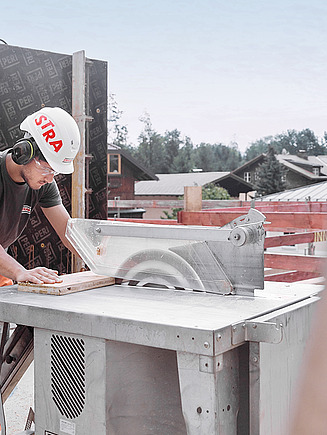 Zwei Bauarbeiter befüllen ein Fundament mit Beton